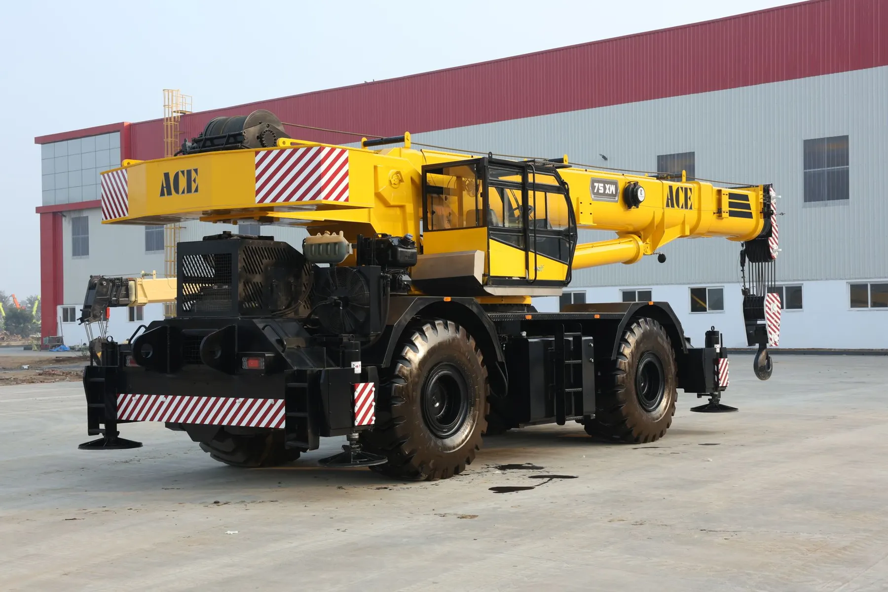 A 75xw model ACE mobile crane on a construction site in Faridabad, India, showcasing its robust design.